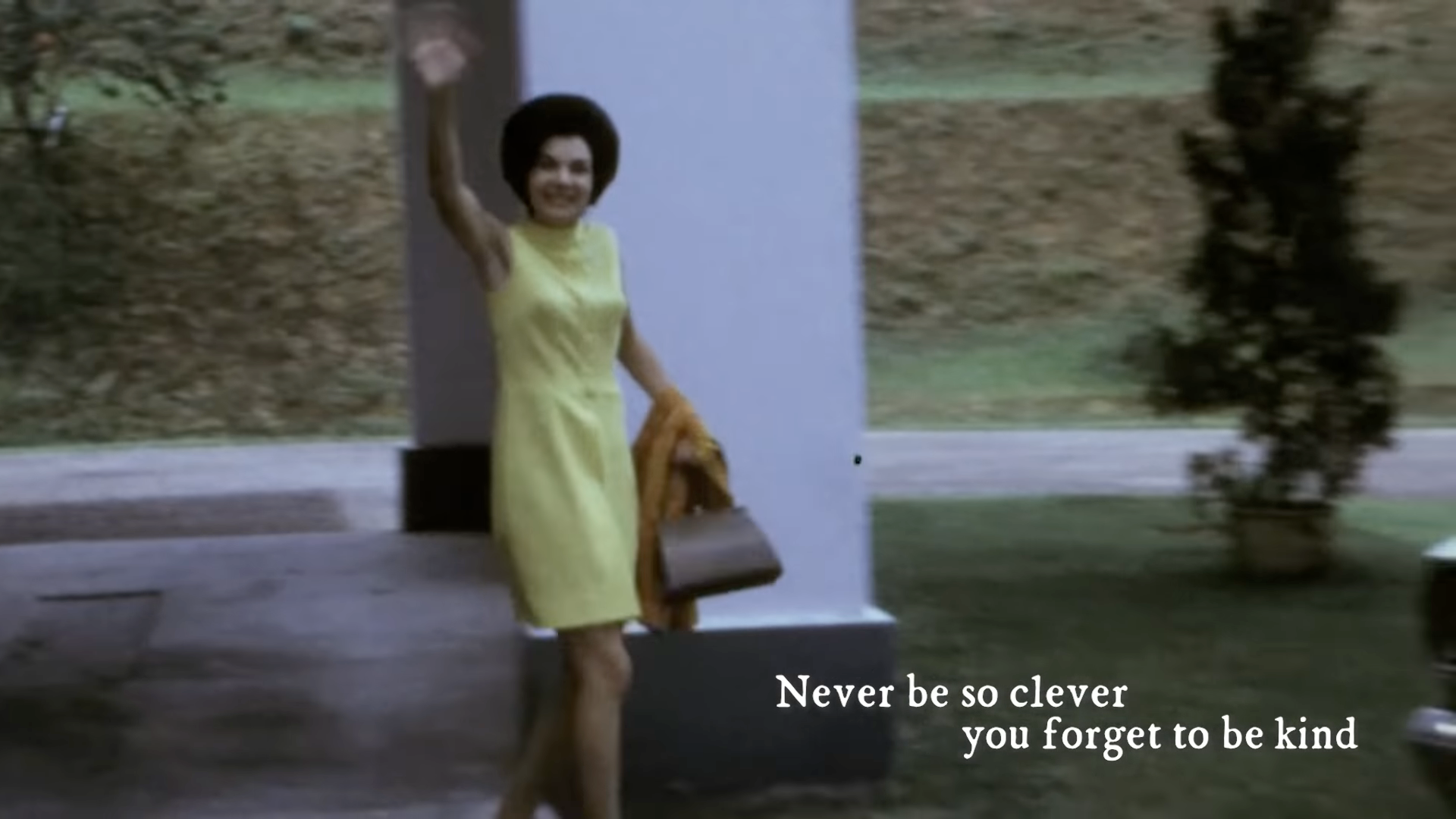 A screencap from the official lyrics video for 'Marjorie'. Video footage of Marjorie in a yellow dress, with the lyrics 'Never be so clever, you forget to be kind.'